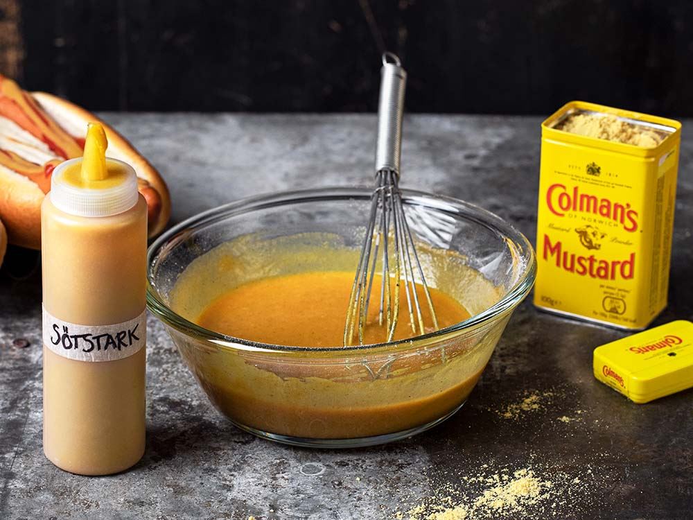 Hemgjord sötstark senap i en skål med en metallvisp